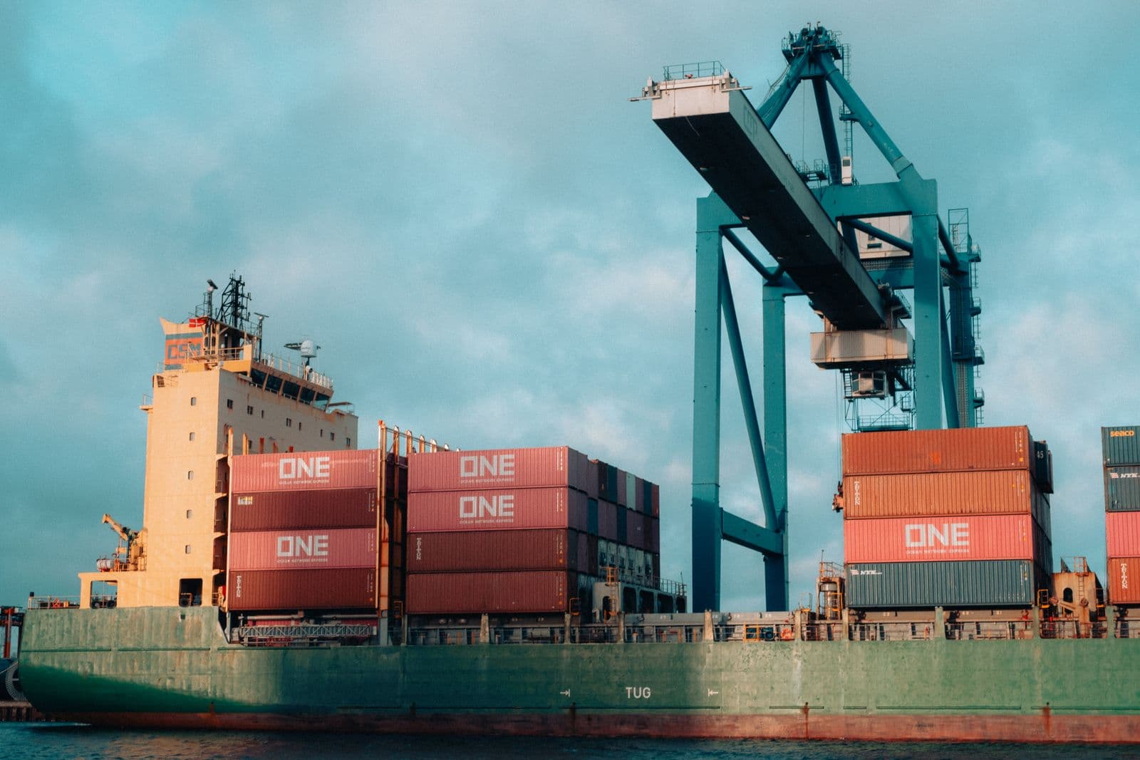 Container ship loading at a busy cargo port