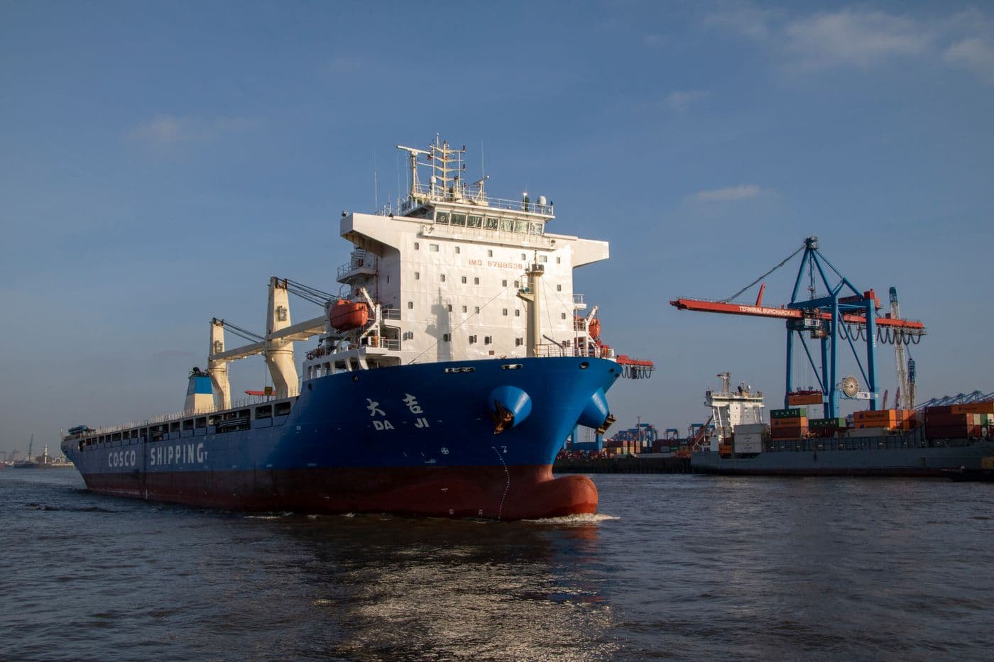 Cargo vessel navigating Hamburg harbour